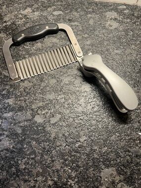 Set of 2 items Pampered Chef Stainless Steel Crinkle Cutter  and a garlic press.